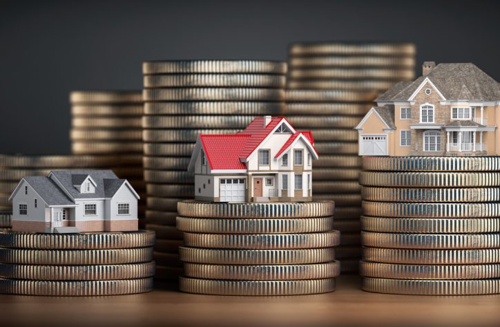 Houses of different size with different value on stacks of coins. Concept of  property, mortgage and real estate investment.  3d illustration